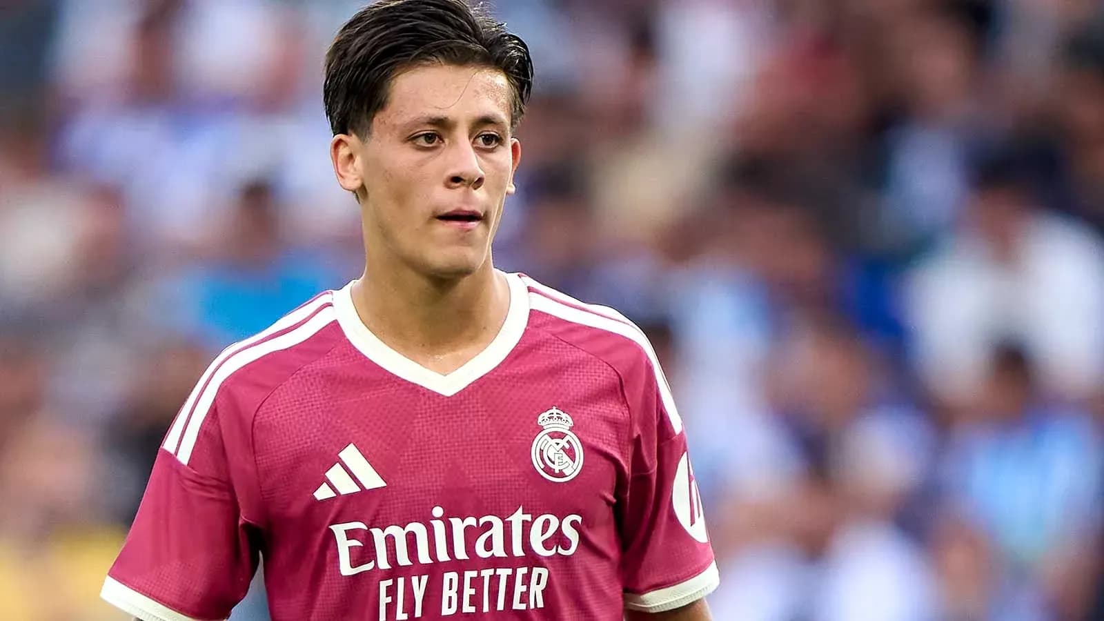 Player wearing pink Real Madrid kit on field