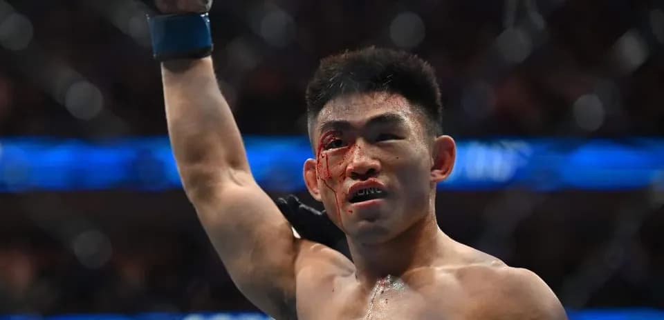 Fighter celebrating victory with a bloodied face
