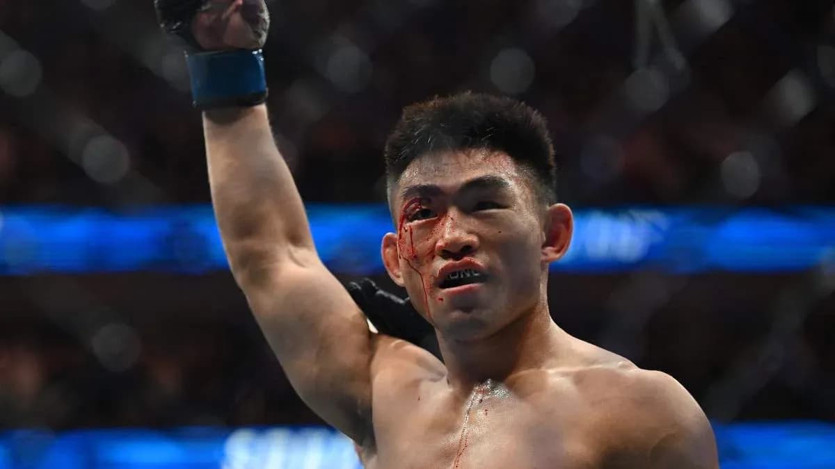 Fighter celebrating victory with a bloodied face