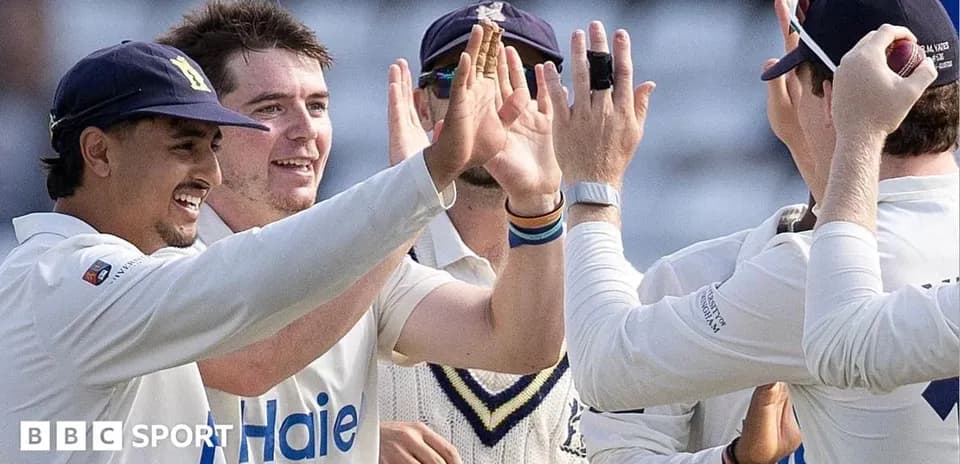 Cricket players celebrating a wicket together