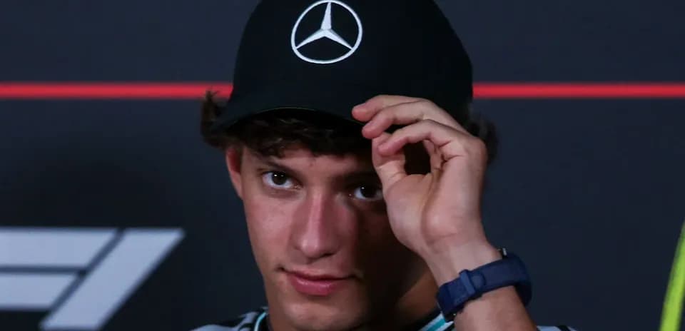 Young man adjusting his cap at press conference