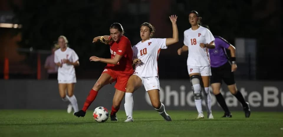 Two players contesting the ball during soccer match