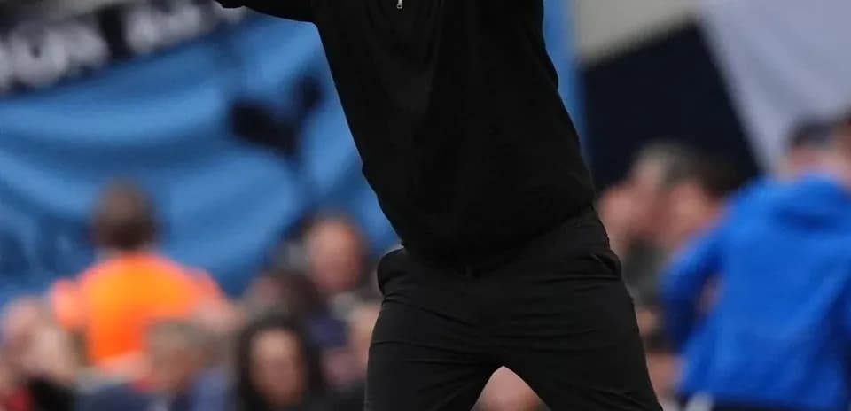 Coach gesturing passionately on the sideline