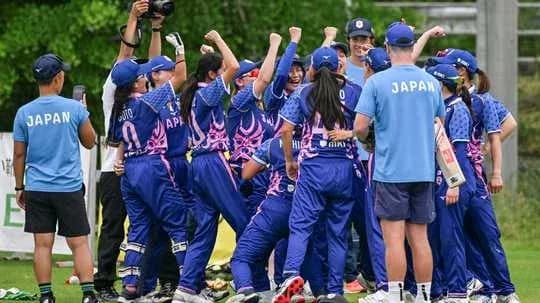 Japanese women's cricket team celebrating victory together Japanese women's cricket team celebrating victory together