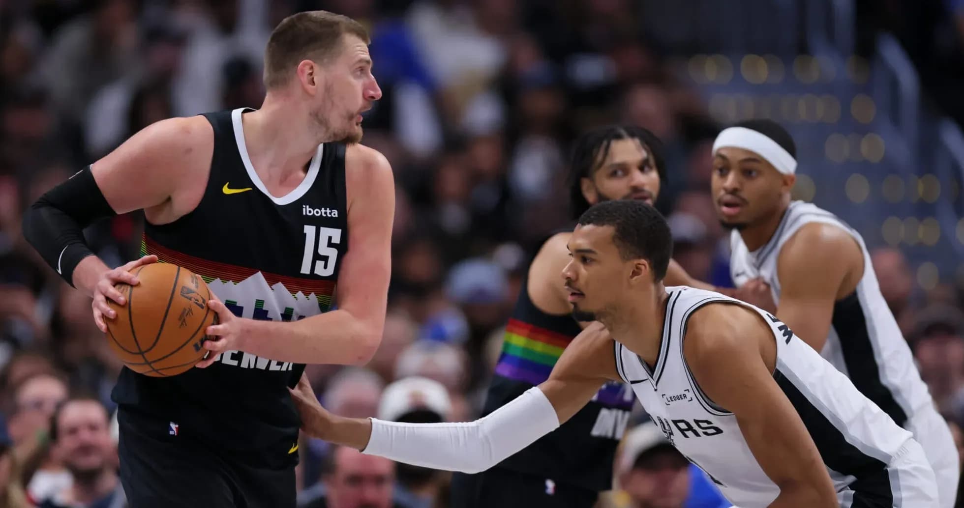Player dribbling basketball while being defended