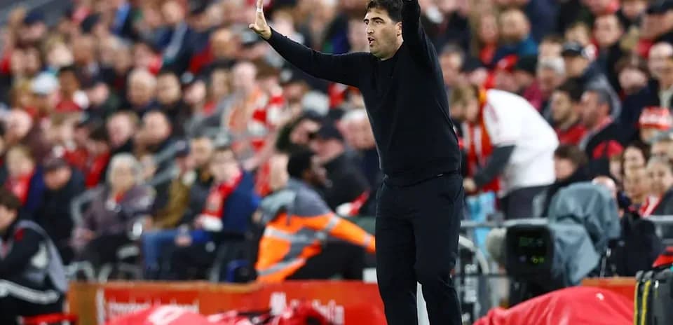 Coach gesturing during a football match on the sideline