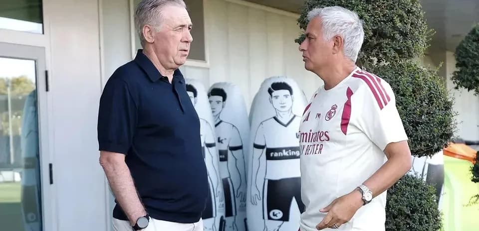 Two football coaches discussing at training ground