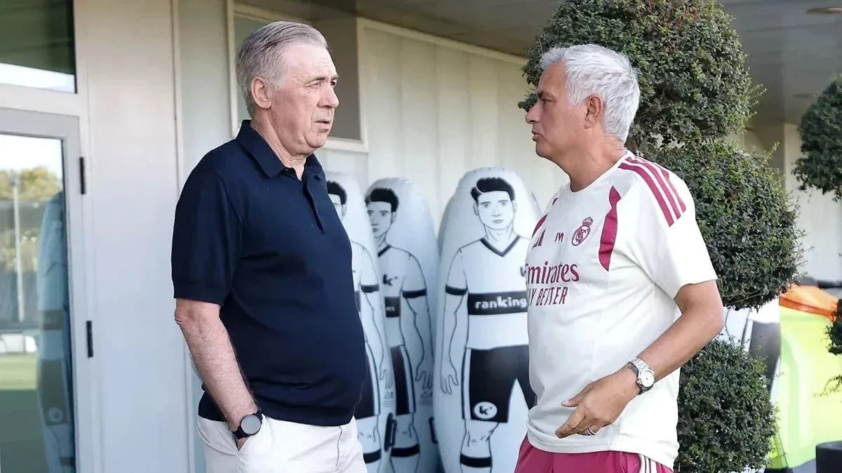 Two football coaches discussing at training ground