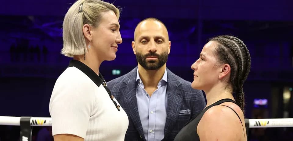 Two fighters facing off before a match with a referee