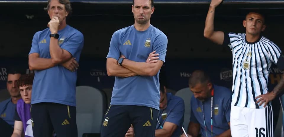 Coaches and staff observing from the bench during match