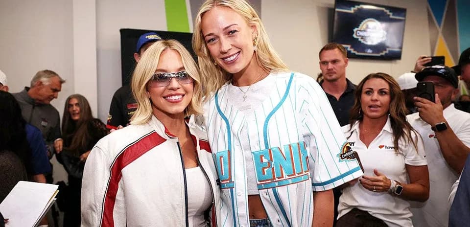 Two women posing together at event venue