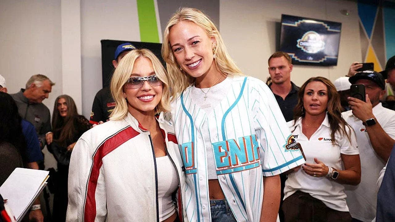 Two women posing together at event venue