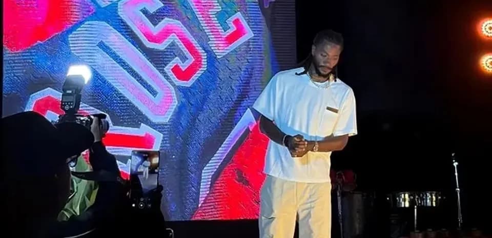 Performer on stage with bright background lights