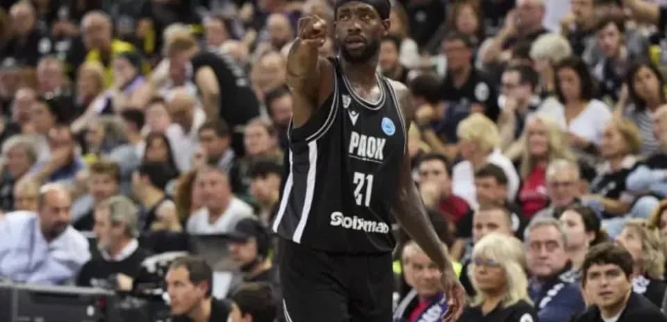 Player in black jersey gesturing to crowd during game