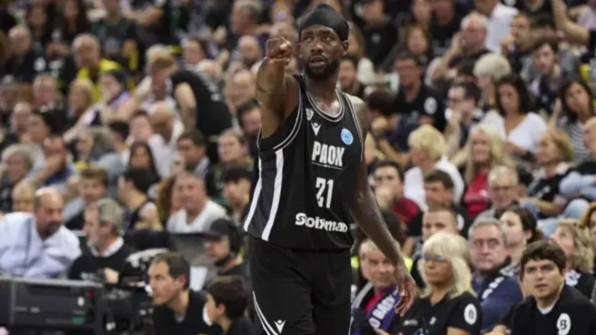 Player in black jersey gesturing to crowd during game