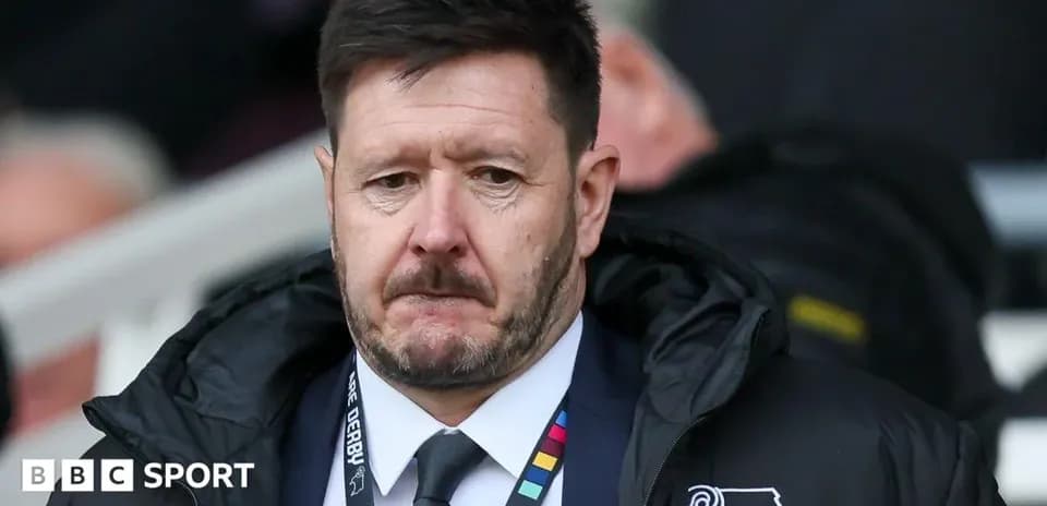 Manager in a coat at the sidelines during match