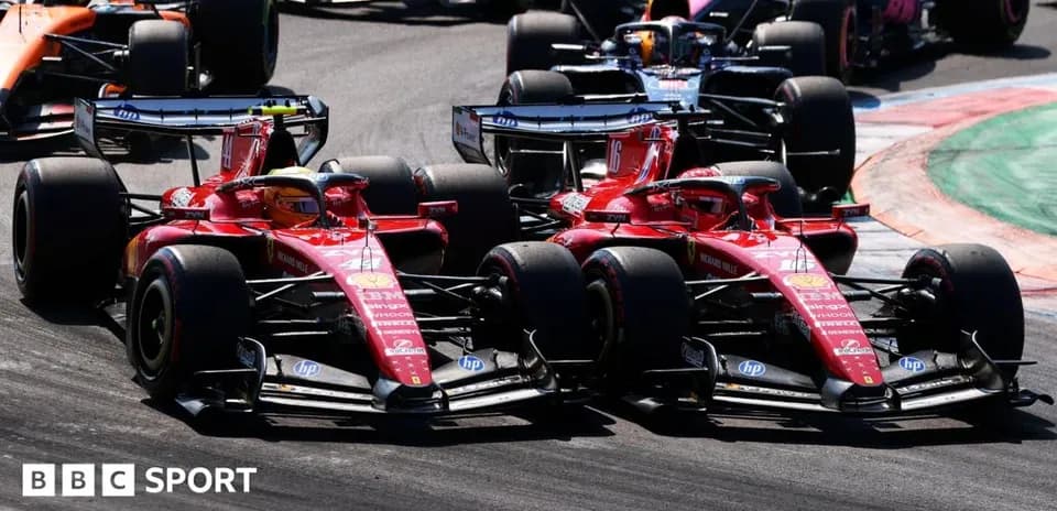 Two Ferrari cars racing closely on the track