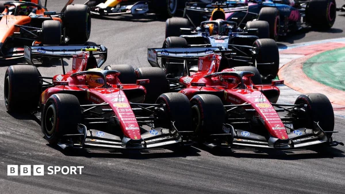 Two Ferrari cars racing closely on the track