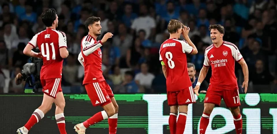 Arsenal players celebrating a goal on the pitch