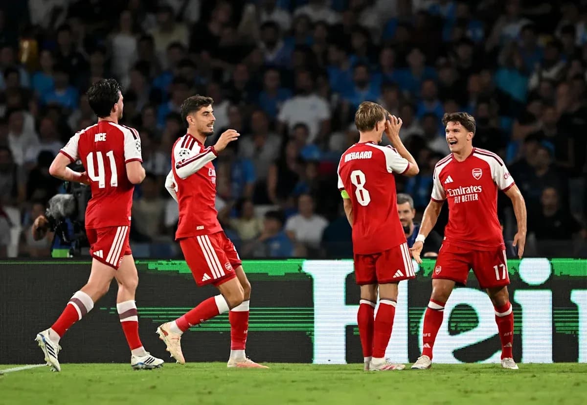 Arsenal players celebrating a goal on the pitch