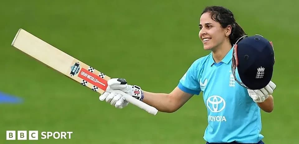 Batter celebrating with bat and helmet after scoring