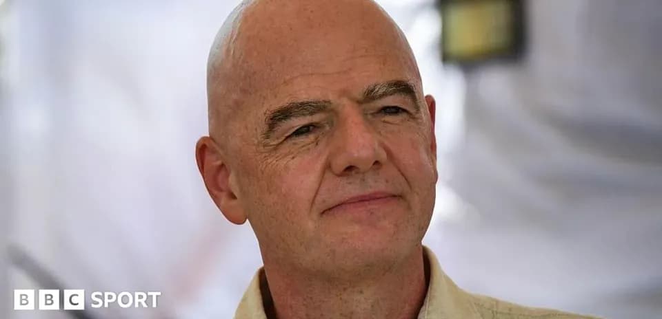 Man with bald head speaking at an event