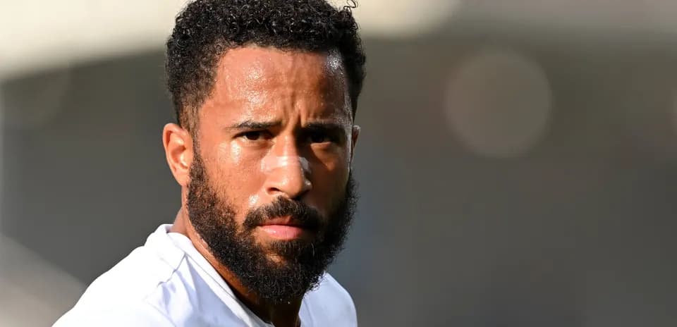 Player with beard and bandage on nose looking ahead