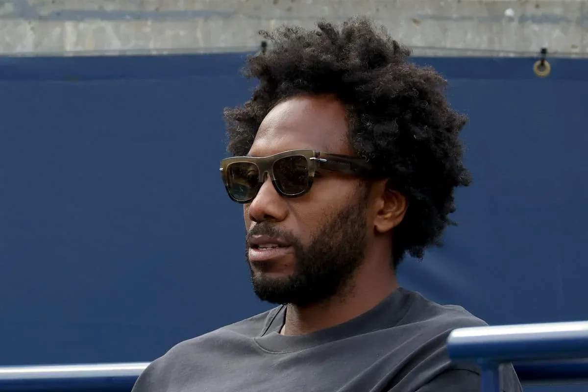 Person wearing sunglasses sitting outdoors