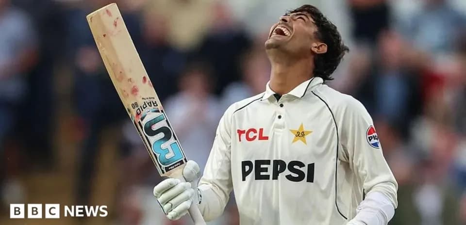 Cricketer celebrating with bat raised in joy