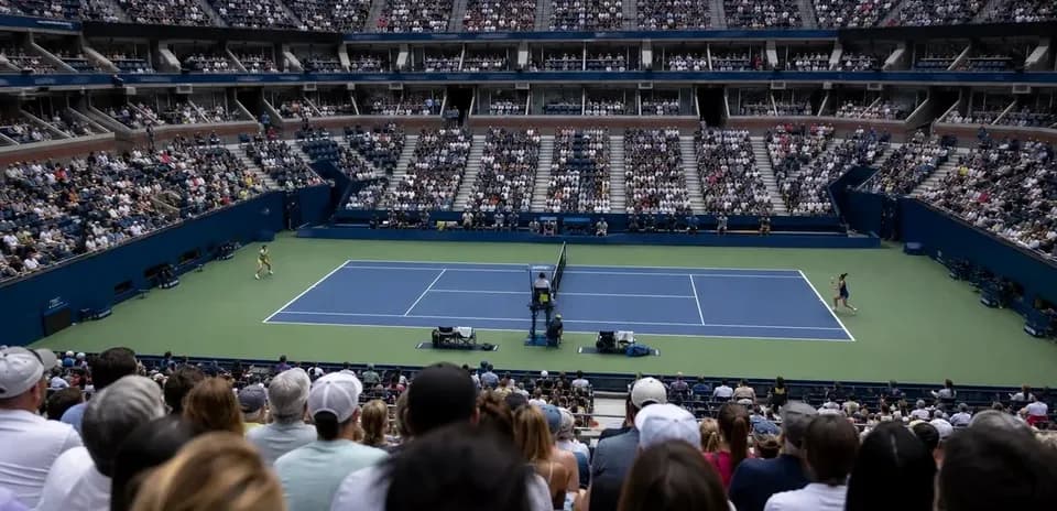 Tennis match in a packed stadium during tournament