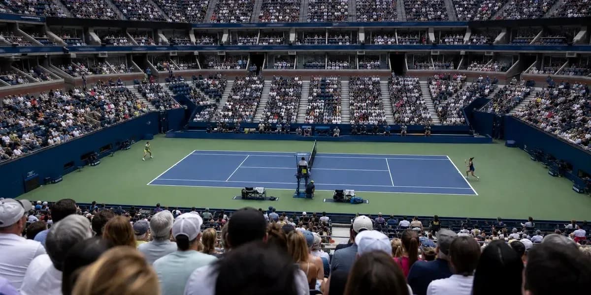 Tennis match in a packed stadium during tournament