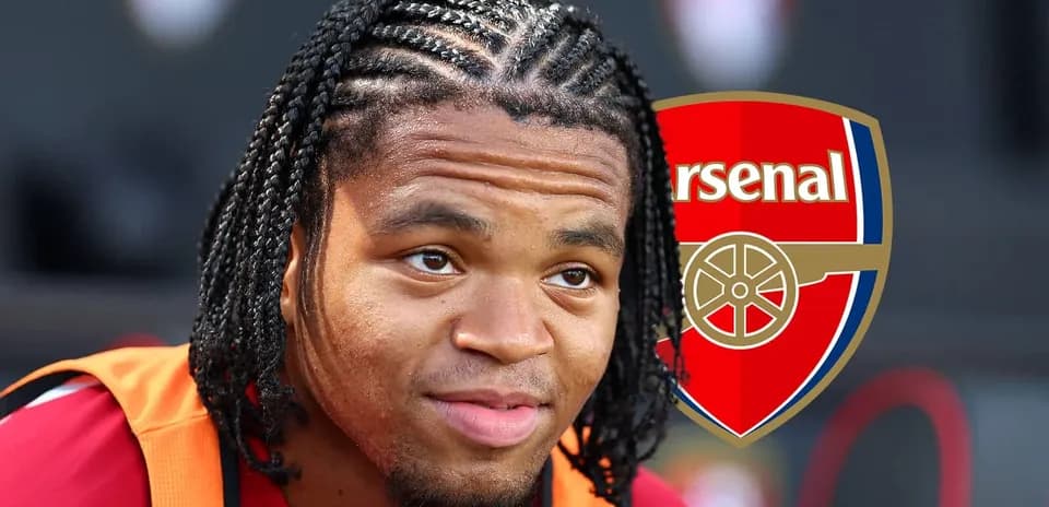 Player with braided hair near Arsenal logo
