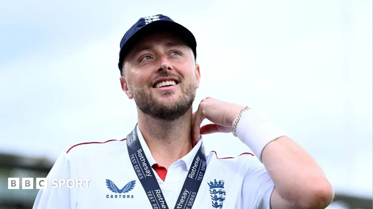 Cricketer wearing medal, smiling at the camera