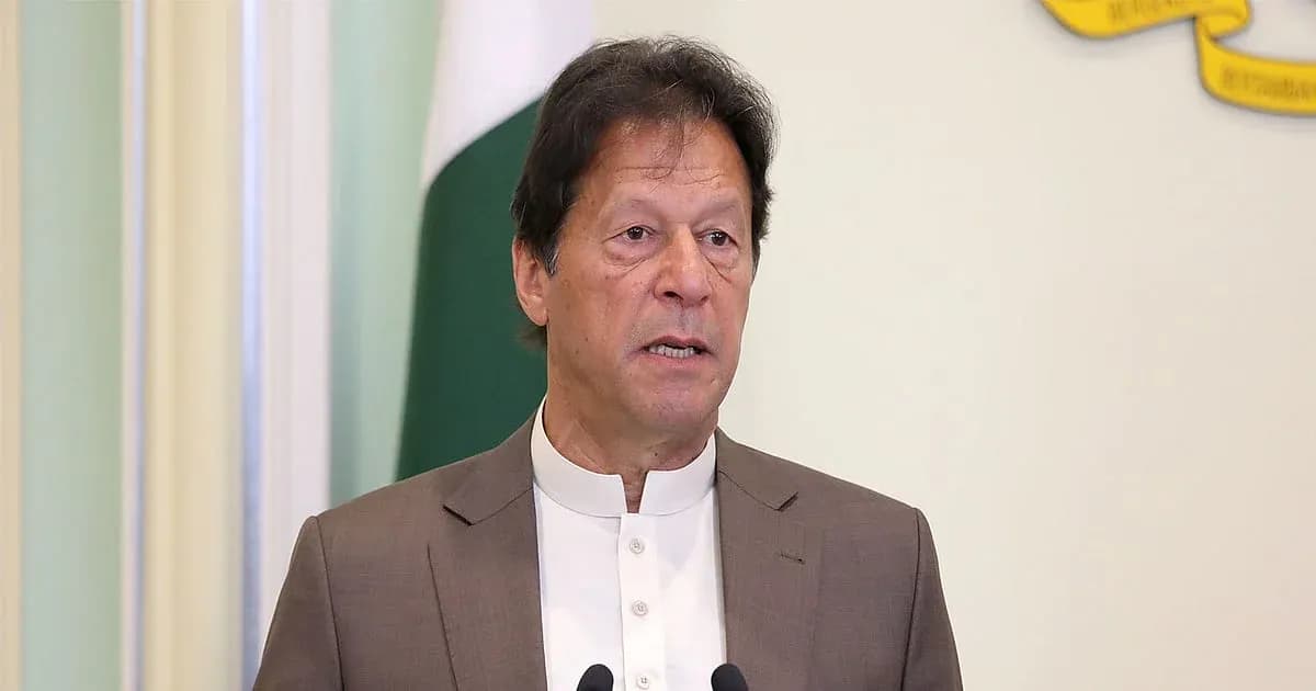 Man speaking at a podium with flags in background