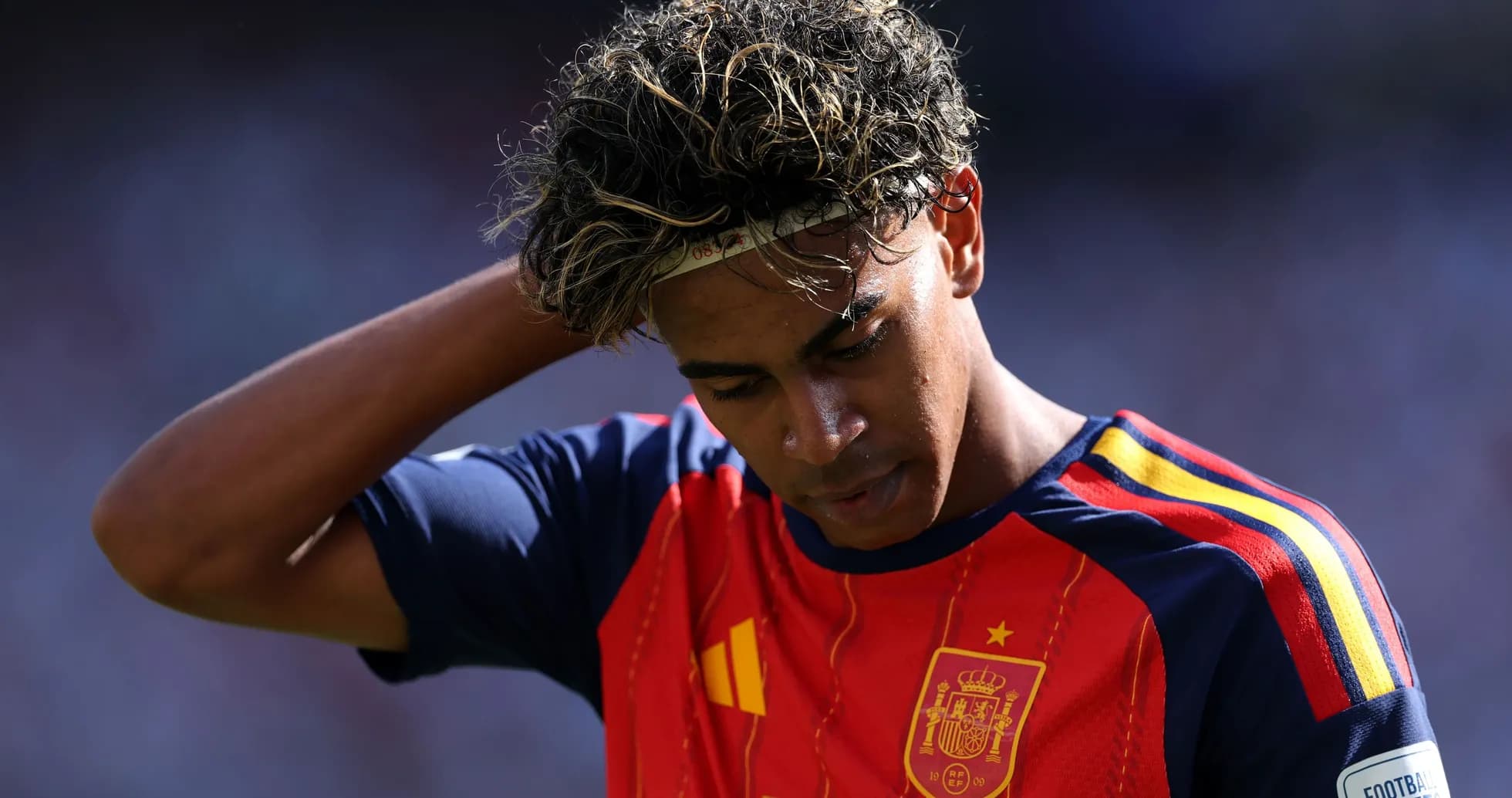 Player in Spain jersey with head down