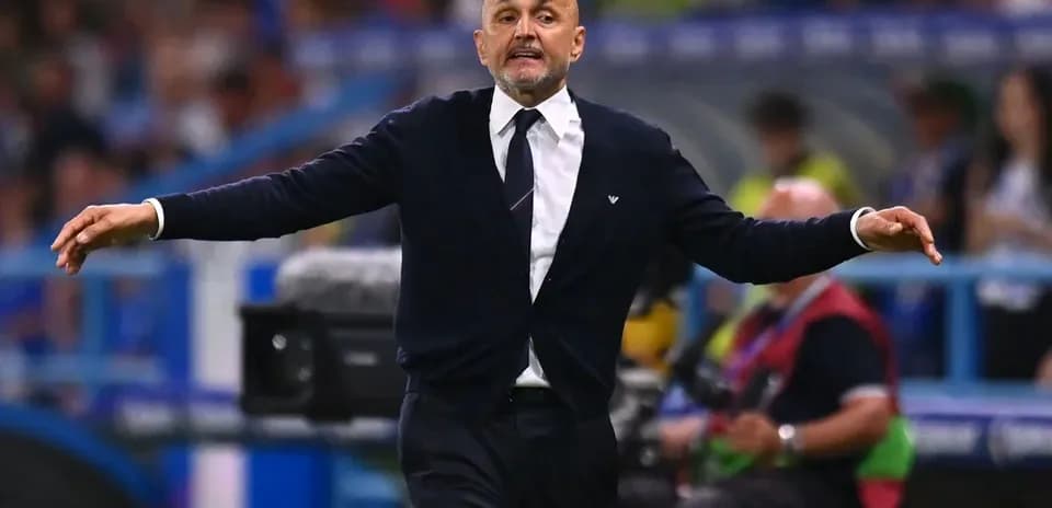 Coach gesturing animatedly on the sidelines