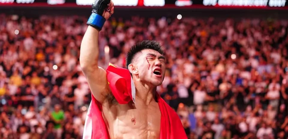 Fighter celebrating with flag after victory in arena