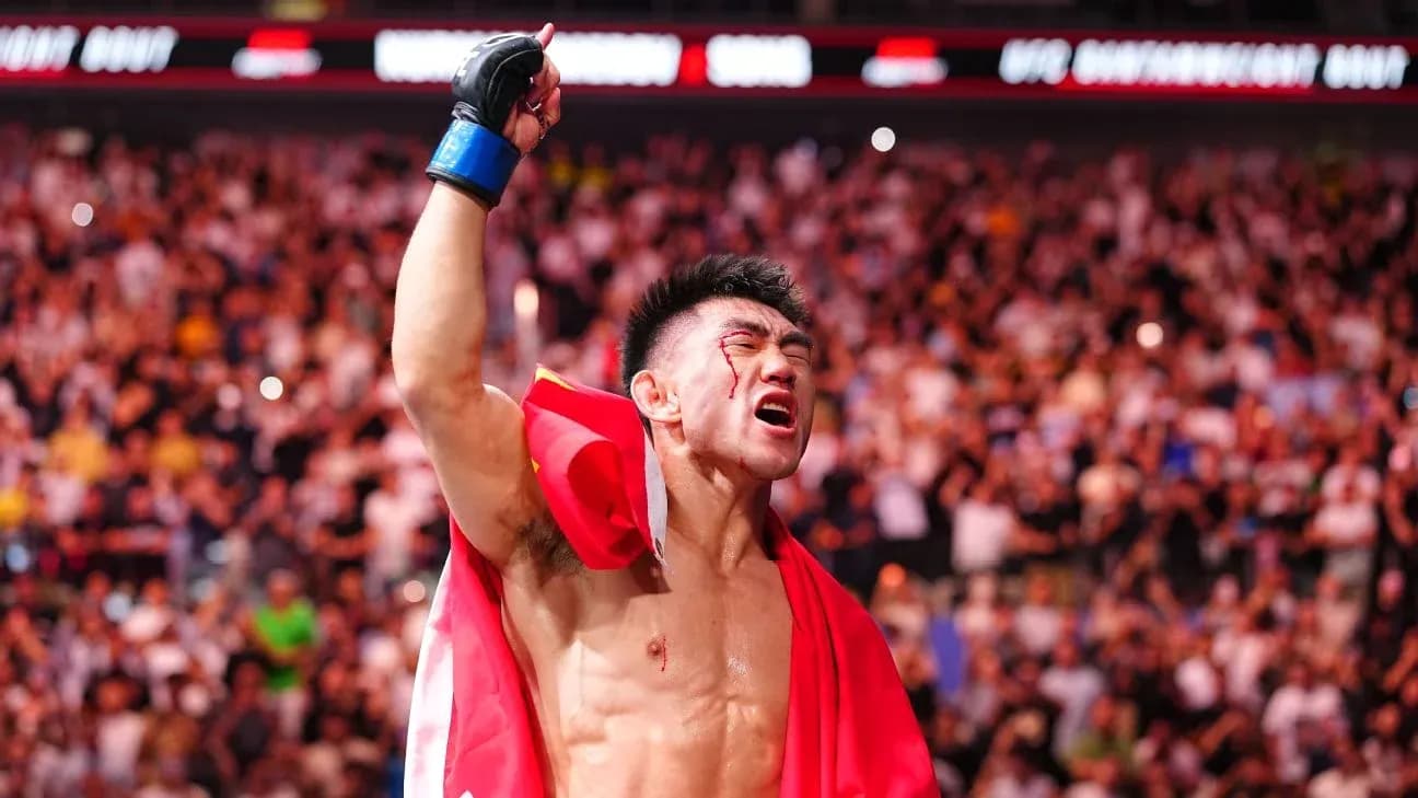 Fighter celebrating with flag after victory in arena