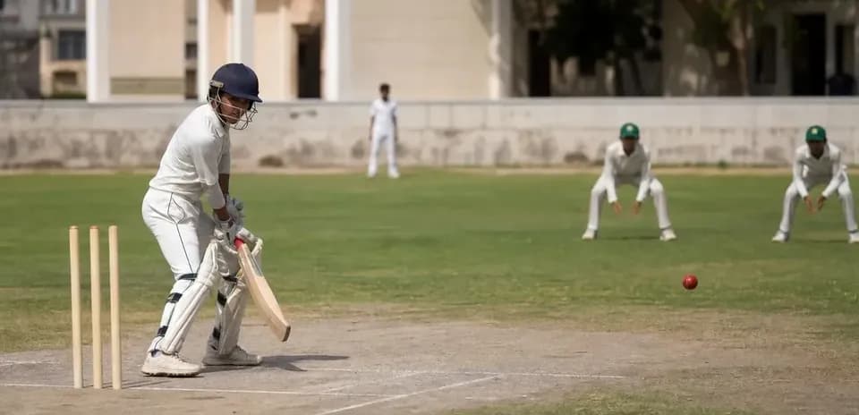 Batsman preparing to hit ball in cricket match