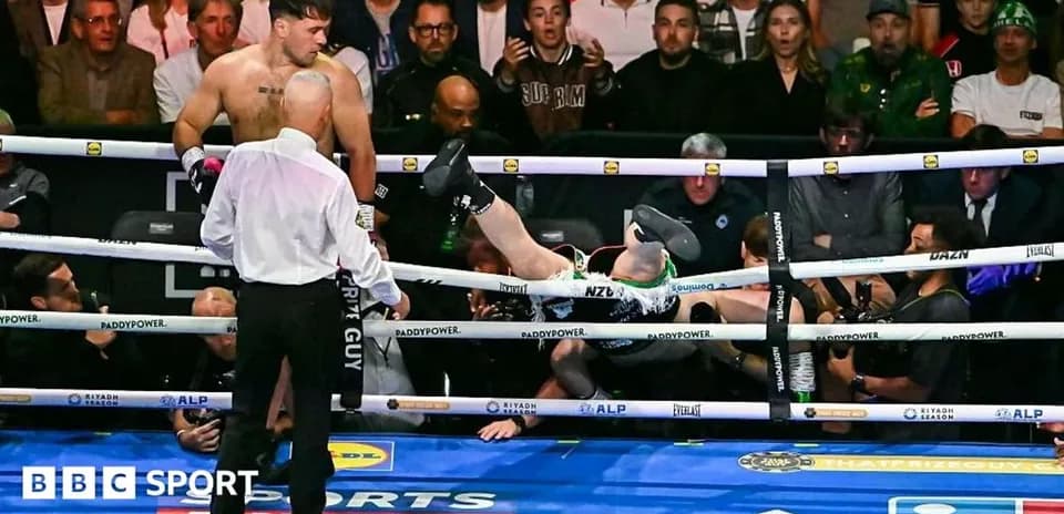 Boxer knocked out, falling between the ropes