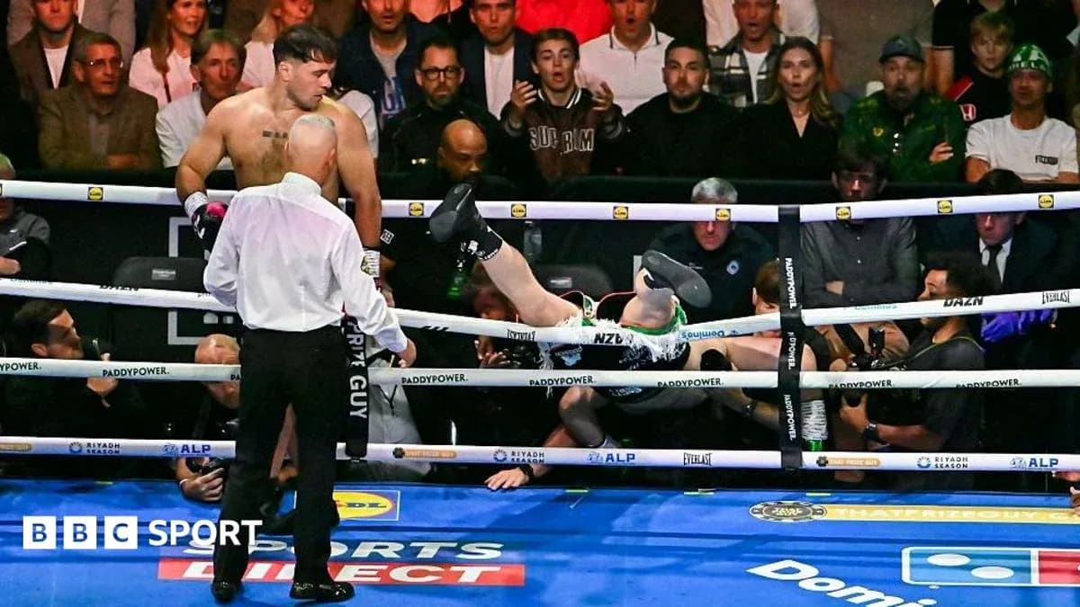 Boxer knocked out, falling between the ropes