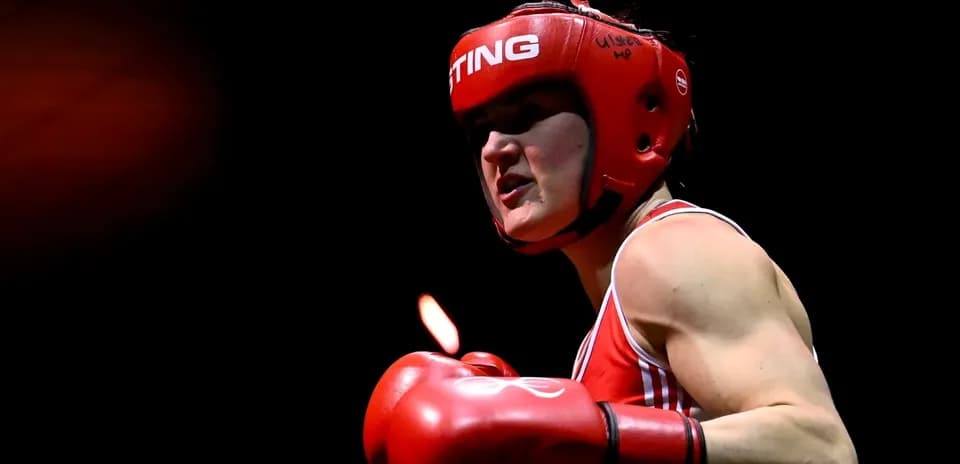 Boxer in red gear preparing to strike