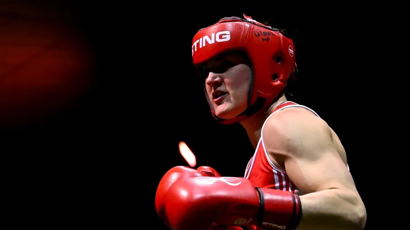 Boxer in red gear preparing to strike Boxer in red gear preparing to strike