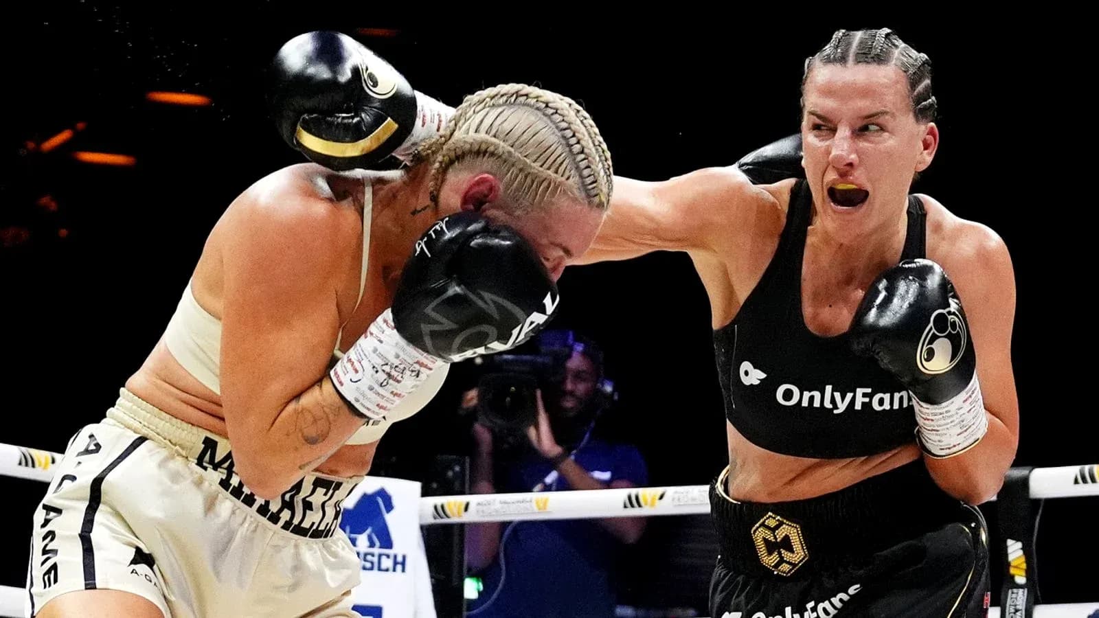 Two female boxers exchanging punches in the ring