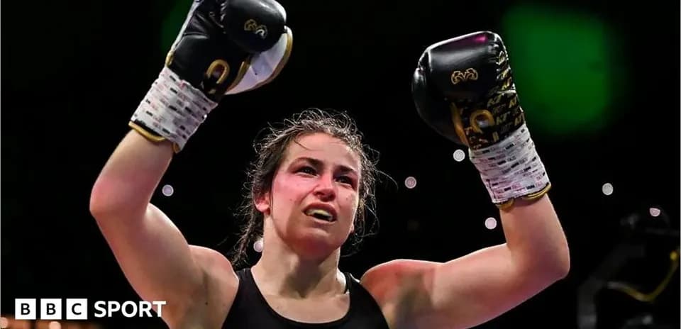 Boxer celebrating victory with raised gloves in ring