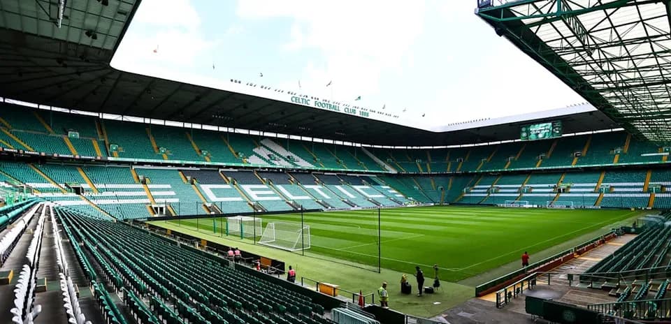 Empty Celtic Park stadium with green seating and pitch