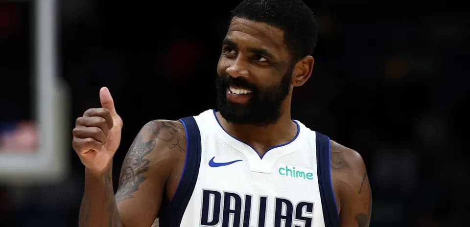 Basketball player in Dallas Mavericks jersey giving thumbs up