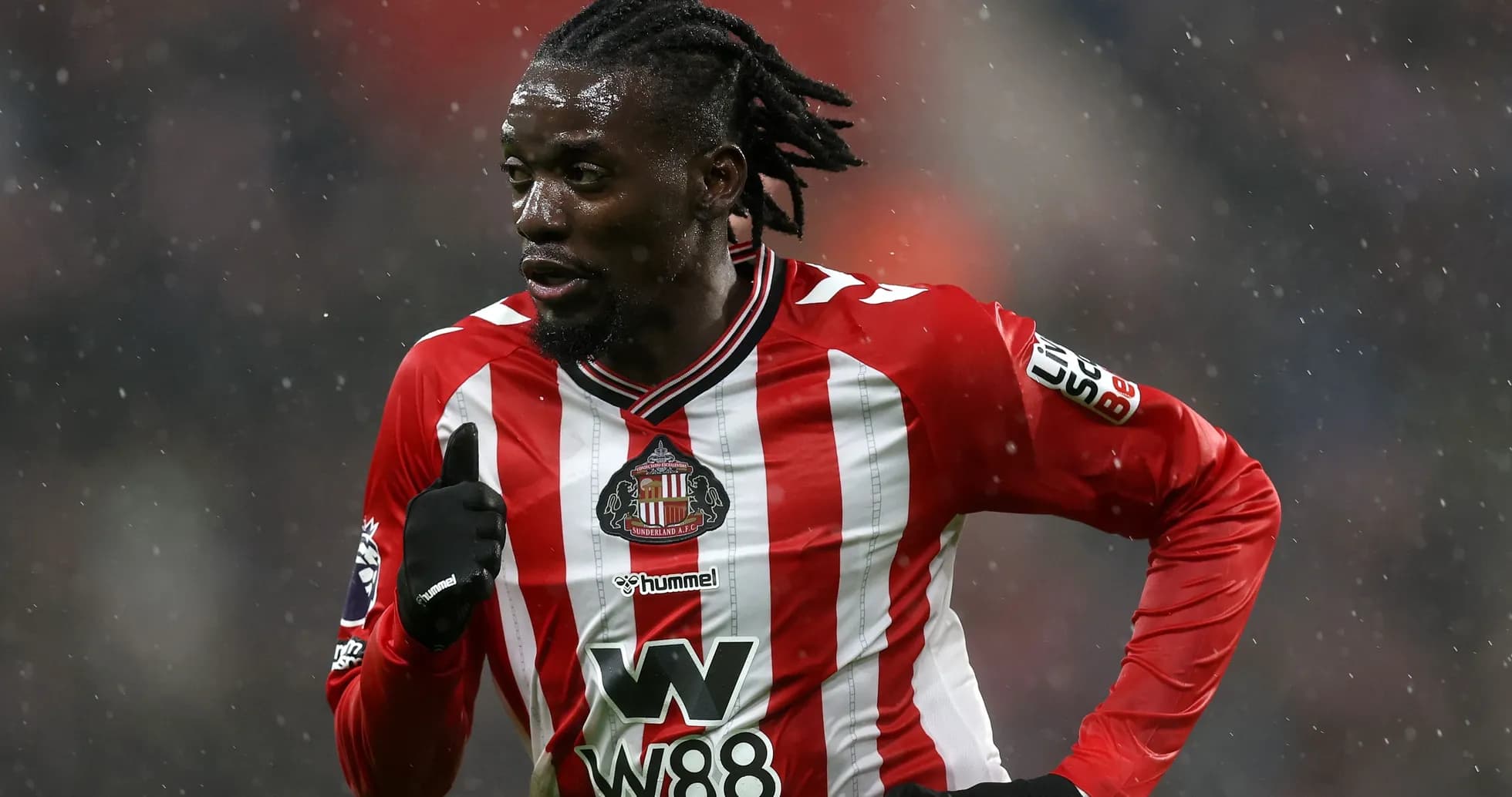Sunderland player running during a snowy match