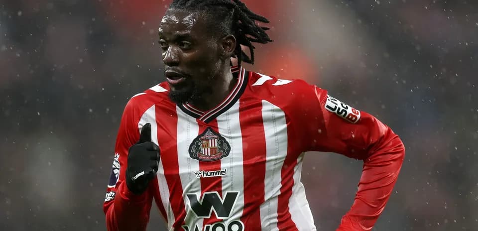 Sunderland player running during a snowy match