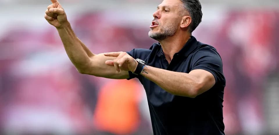 Coach giving instructions from the sidelines during match
